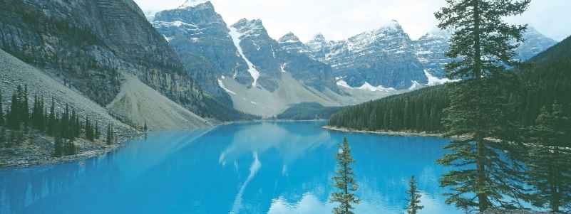 Reflection of snowy mountains in a blue lake