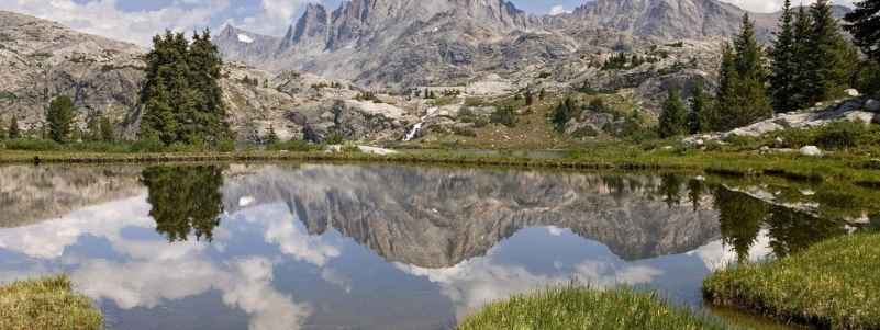 Mountains reflected in a meadow lake