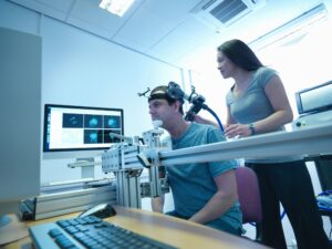 A man sitting for a transcranial magnetic stimulation session